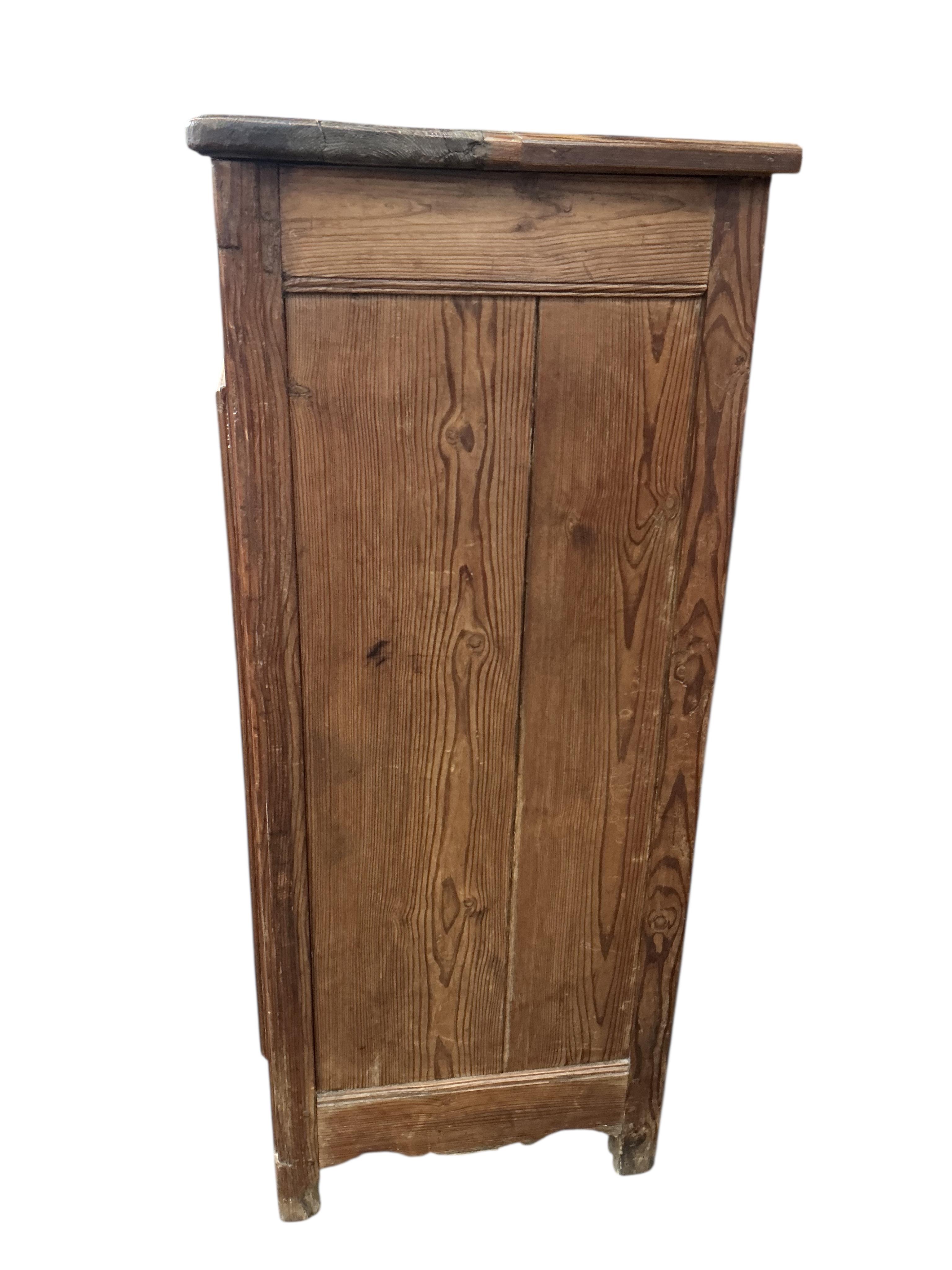 An early 19th century French pitch pine side cabinet, width 109cm, depth 48cm, height 115cm